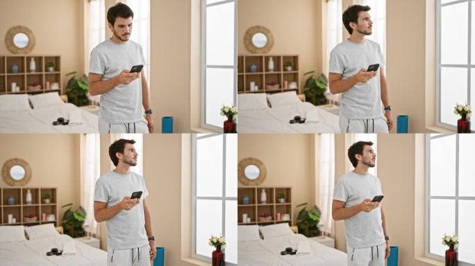 帅气的西班牙裔男子在舒适的卧室里使用智能手机，传达出一种在家的科技感。