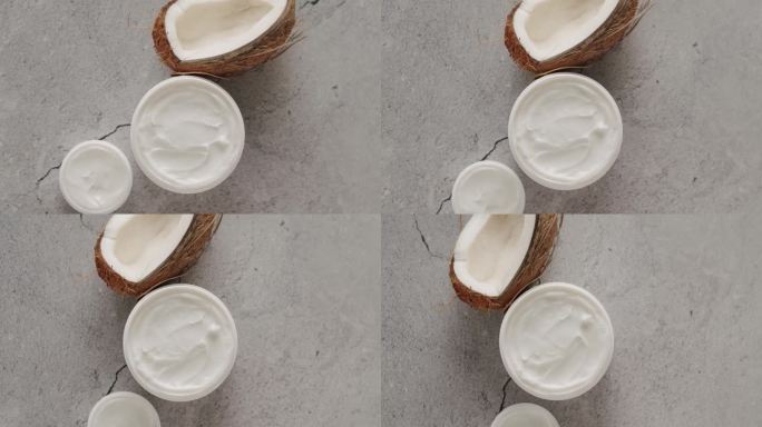 顶视图有机奶油与椰子油在罐子瓷砖背景