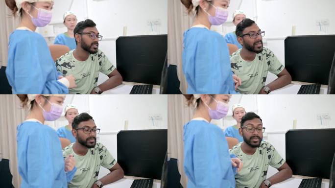 亚裔华裔女牙科医生向病人解释x光检查。