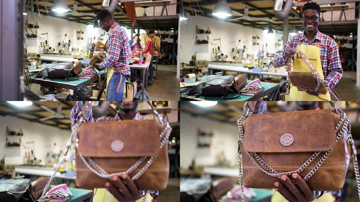 年轻的非洲裔男裁缝拿着自己做的皮包