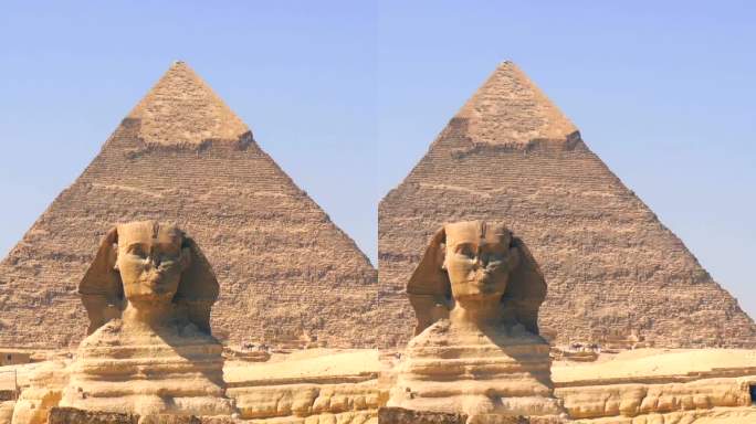 一个年轻人穿着蓝色的衣服，戴着头巾，走在银座金字塔旁边的银座狮身人面像上。开罗,埃及