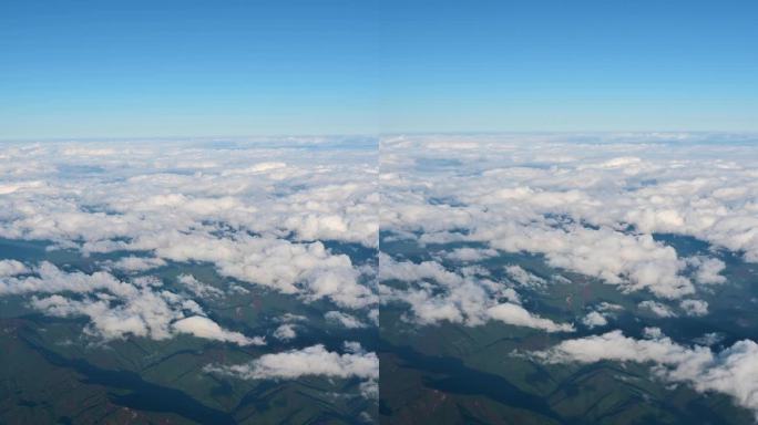 从飞机上鸟瞰日本上空的自然日出天空、绿色景观山和白云