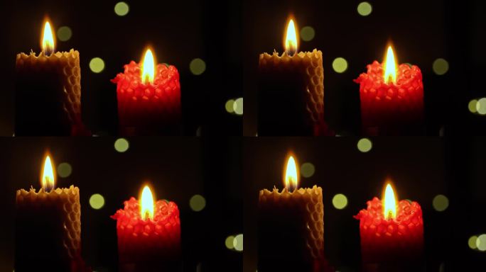 两支蜡烛在黑色背景上燃烧