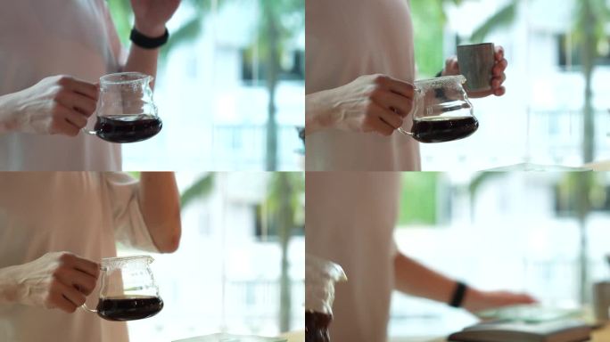 咖啡师正在一丝不苟地测试滴滤咖啡，并熟练地将其倒入一个小杯子中。