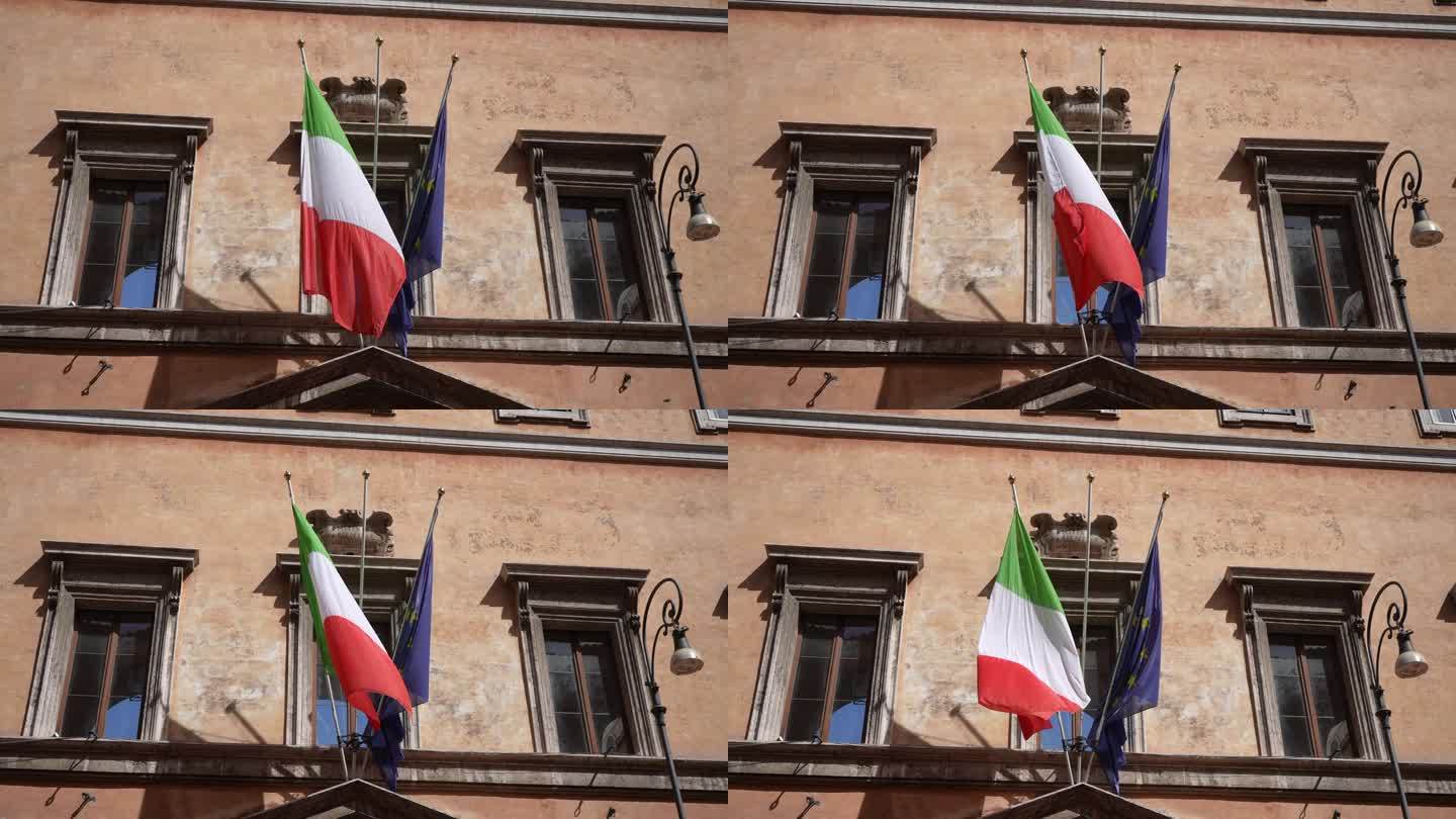 建筑立面上意大利和欧盟国旗一起飘扬的特写低角度视图。金融处理概念，独特的货币和金融债券。