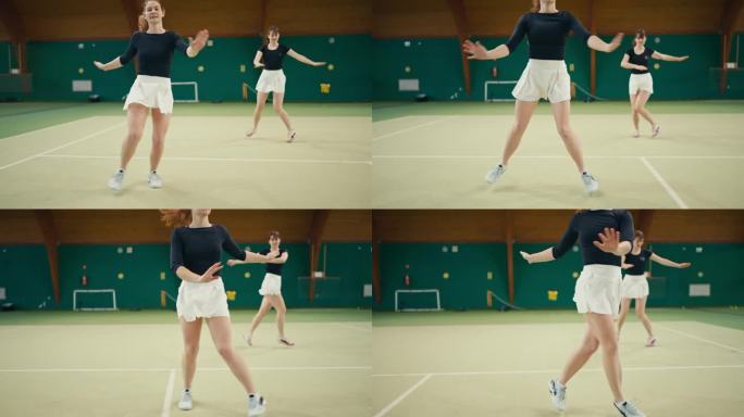 在体育俱乐部，穿着运动服的年轻活跃女网球运动员边踏场地边做热身运动