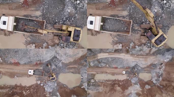 一架动态无人机拍摄的一台挖掘机将其产出倒入采矿卡车。