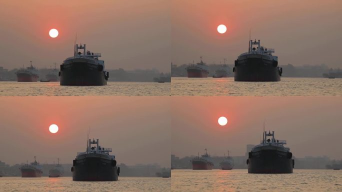 日落时分，孟加拉国吉大港水上的重型集装箱船
