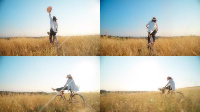 在阳光明媚的日子里，在草地上骑自行车的女人。骑自行车的快乐女人。草地上心满意足的女人。