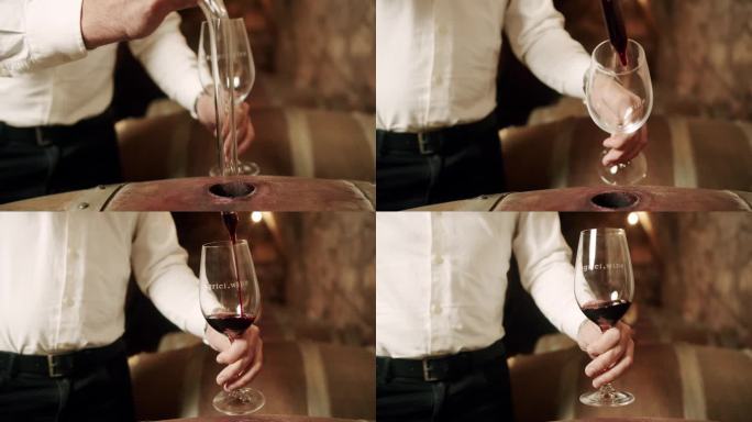男酿酒师在酒厂用移液管将桶装红酒倒入玻璃杯中