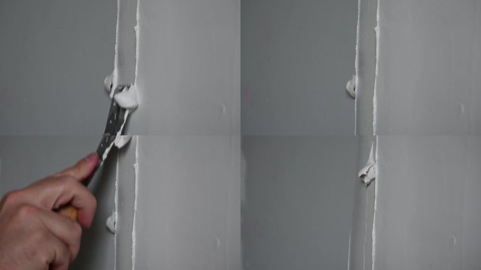 一只手用腻子修补墙壁的特写视频。