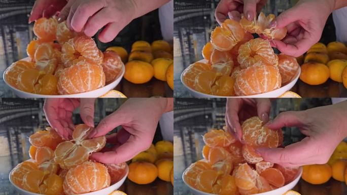 将去皮的橘子放在白色盘子里，切成片。女性的手准备柑桔汁。