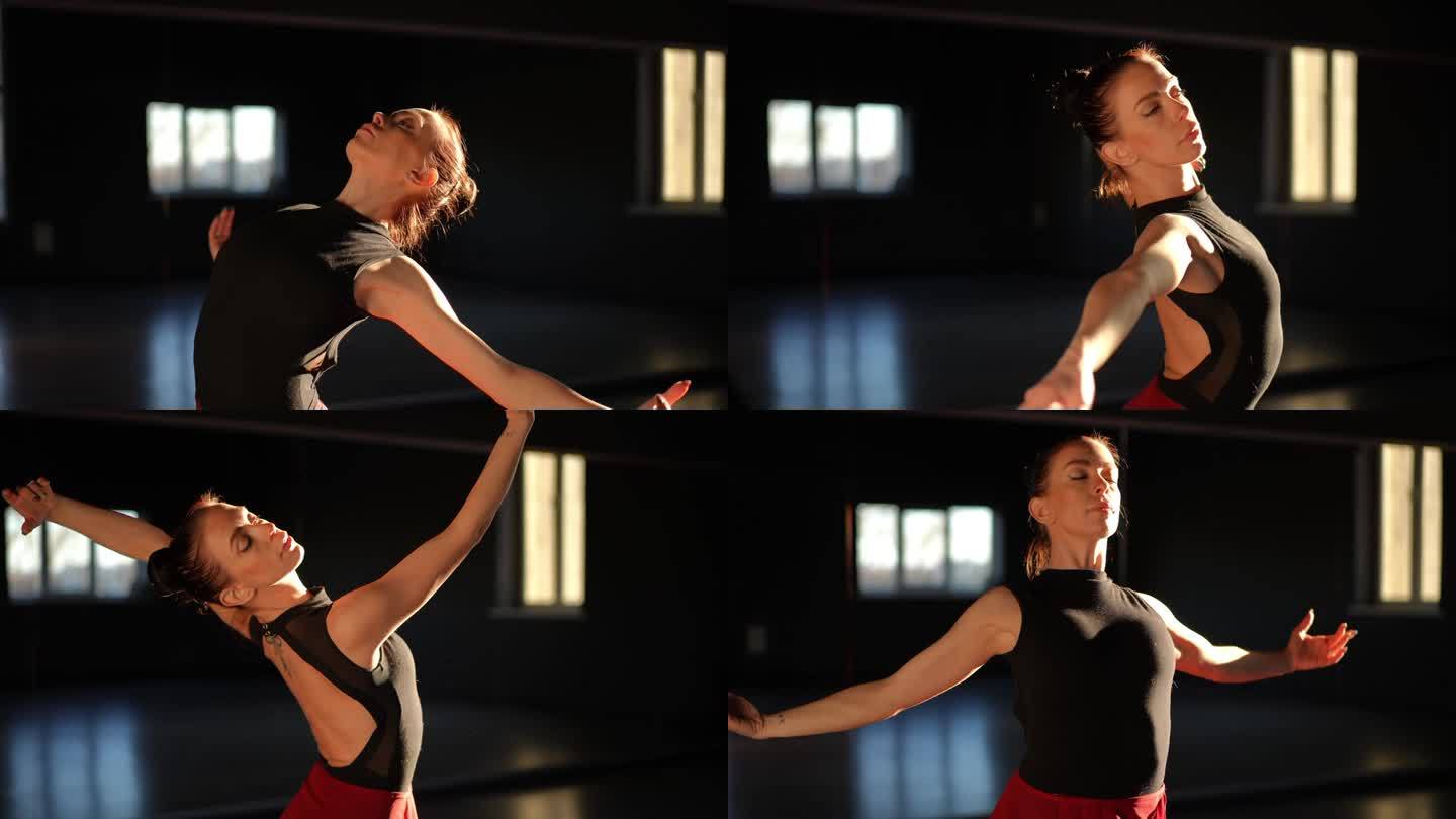 一位美丽的芭蕾舞女演员站在舞蹈大厅里，用她的手臂和身体做着流畅的动作。