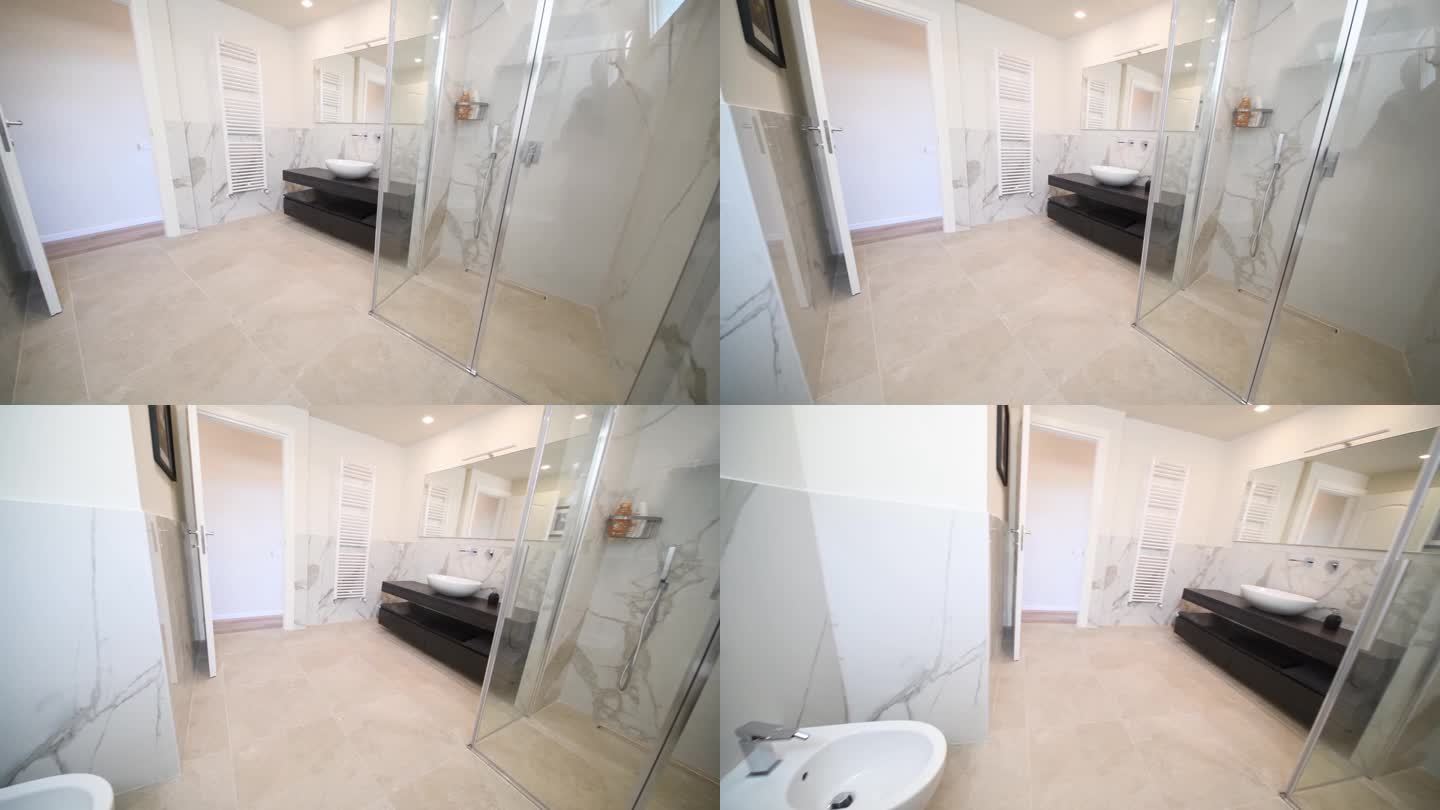 宽敞的灰色浴室，带加热地板，步入式淋浴间和水槽梳妆台。现代浴室内饰