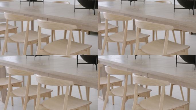 轻巧的木椅，设计优雅，宽敞明亮的用餐区。座位安排在现代餐桌周围，表面抛光。极简主义美学