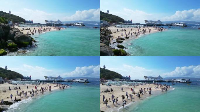 航拍海南三亚玻璃海白沙滩上旅游度假的游客