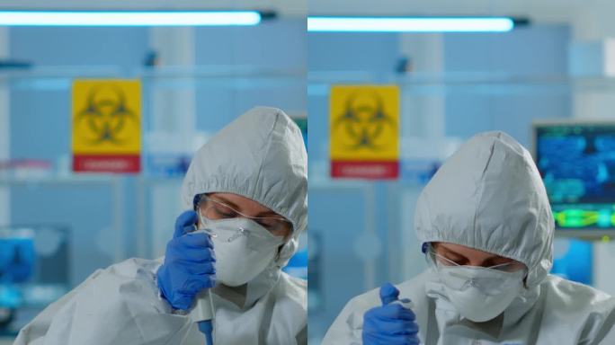 垂直视频:穿着防护服的科学技术人员使用微移管和培养皿分析血液样本