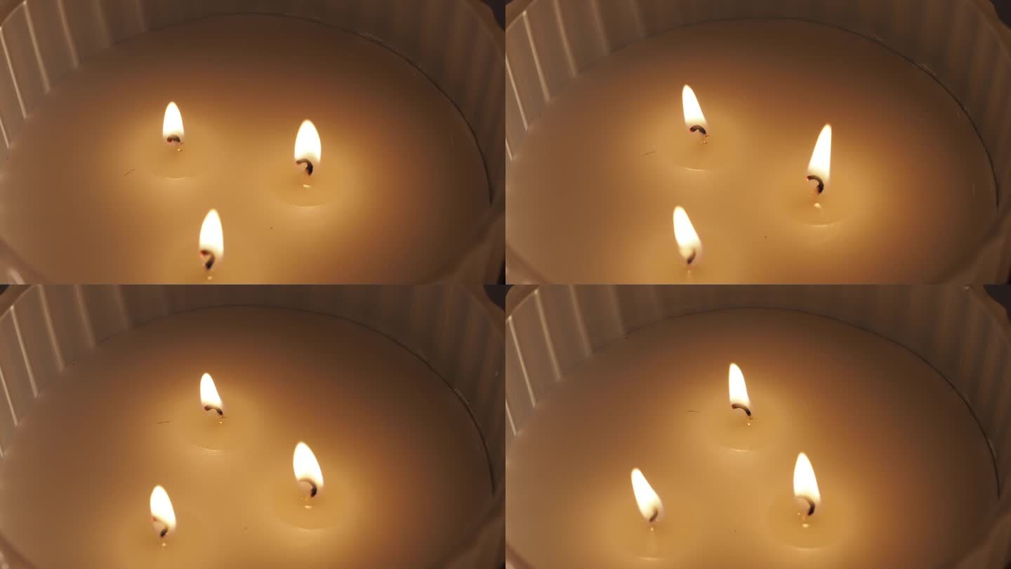 有三个芯的点燃的蜡烛。