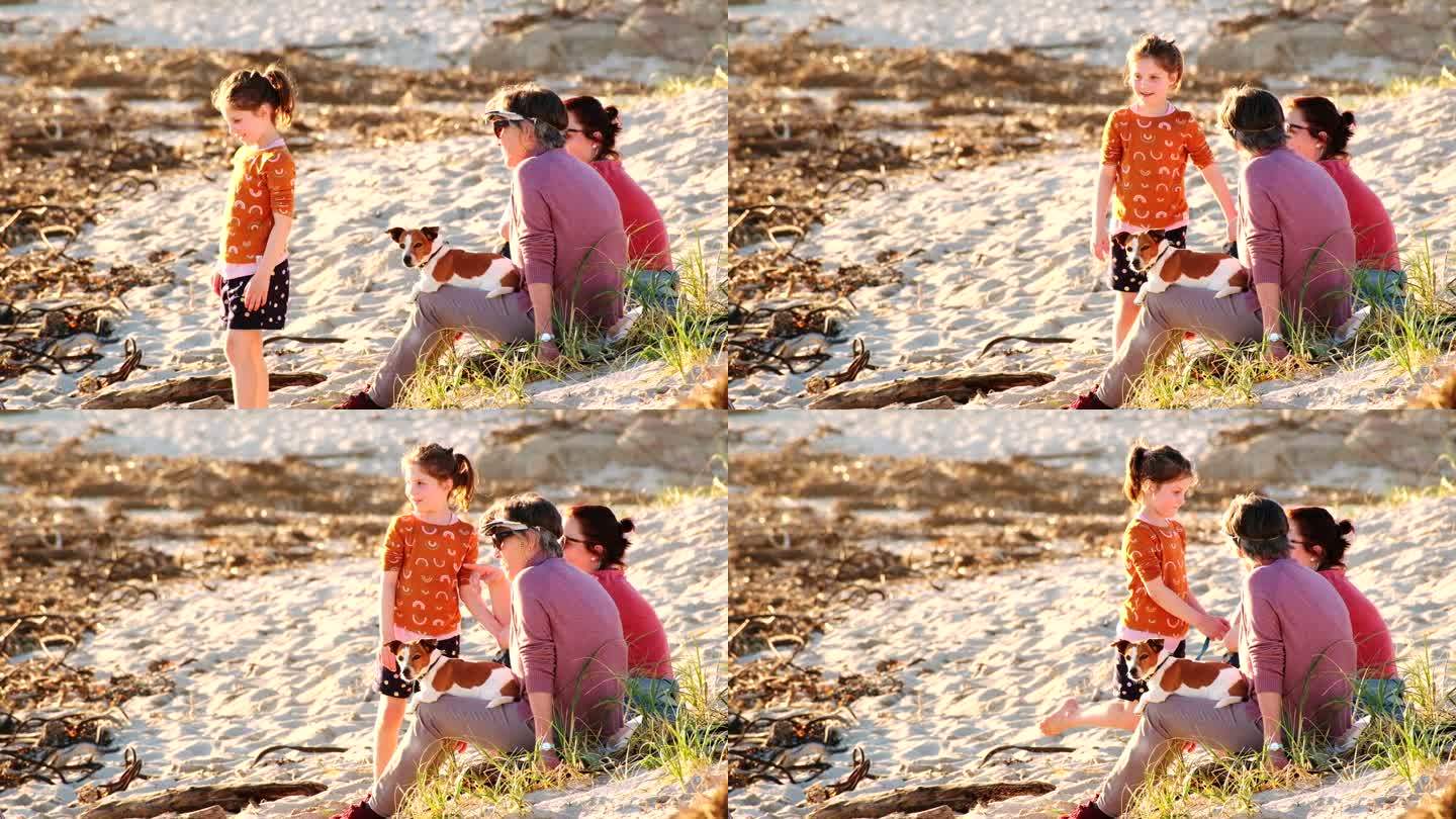 一家三代人带着宠物狗在海滩上共度时光