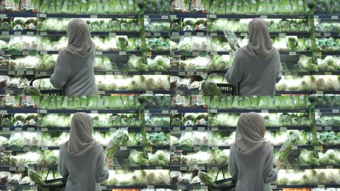 穆斯林妇女在超市冷藏柜里挑选食物的后视图