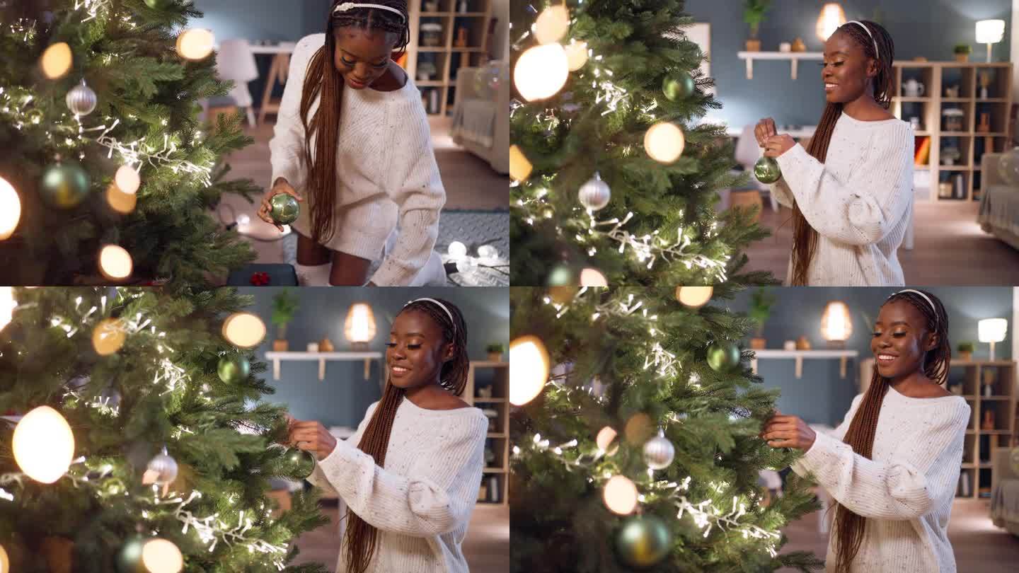 年轻的黑人妇女正在装饰圣诞树