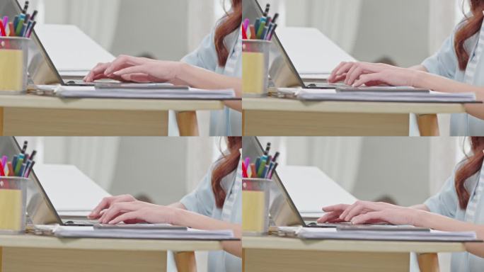 商务女性在电脑键盘上打字的近距离手。女人的手在家里的工作台上聊天或写文章。B卷打字到电脑通讯