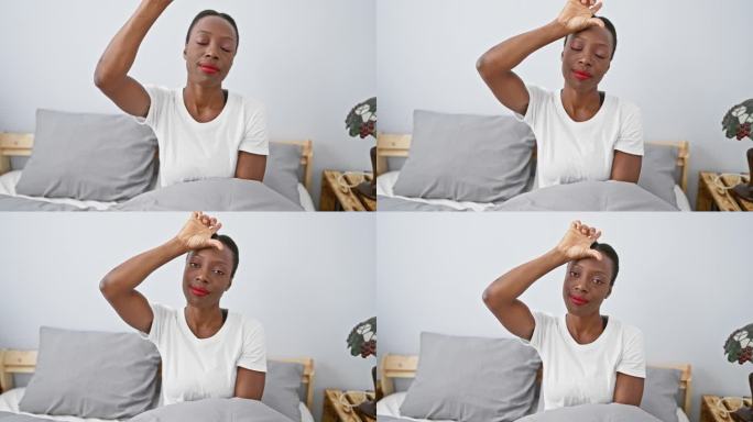 一名非洲裔美国妇女躺在床上放松，用手指在额头上做“失败者”的手势，在舒适的卧室里嘲弄地侮辱别人