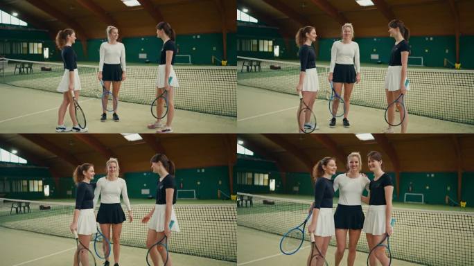 在体育俱乐部的球场上，年轻的女教练和网球运动员手挽着手望着镜头微笑的肖像