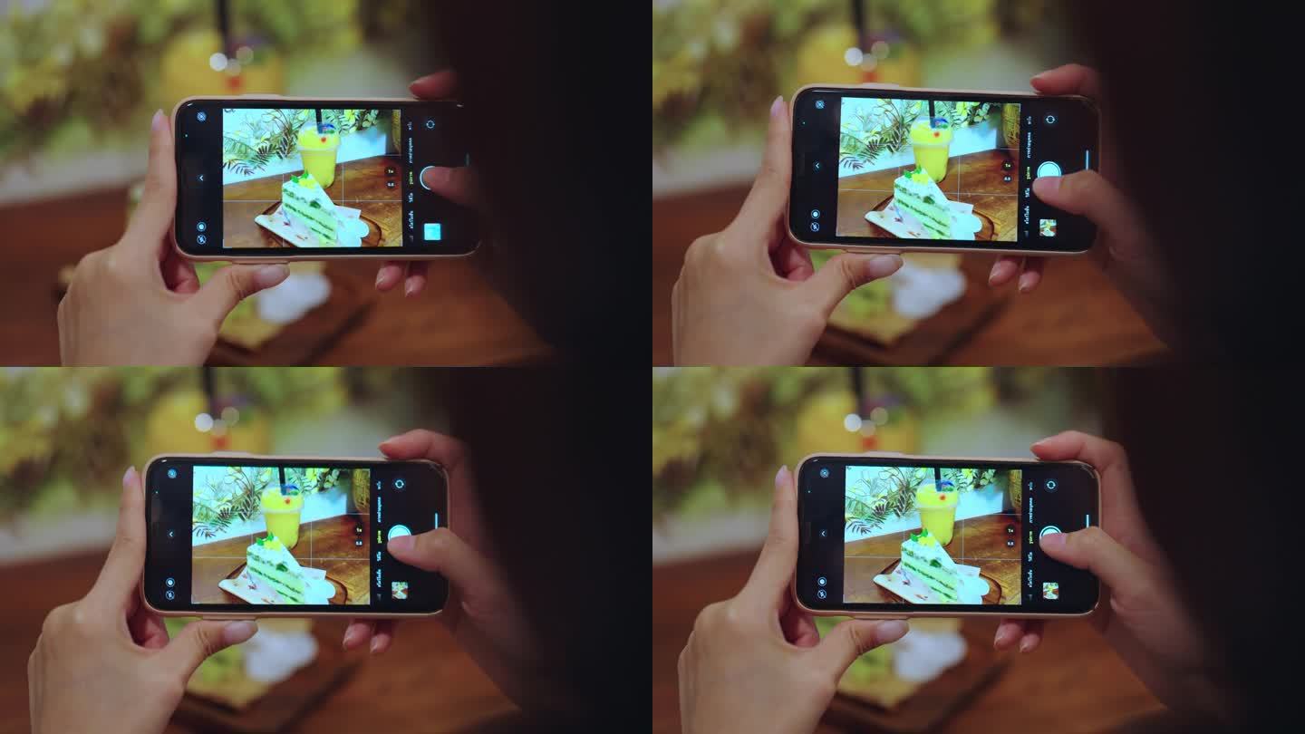 特写镜头捕捉到一位年轻女子的手，她熟练地用手机捕捉到一张视觉上诱人的食物照片。