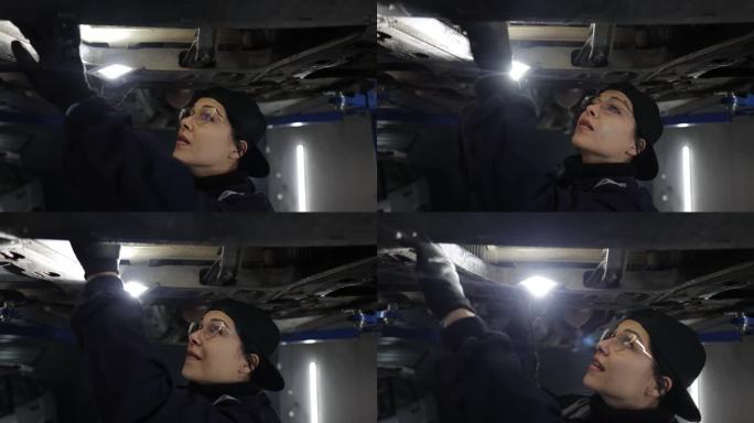 女汽车修理工在汽车修理厂工作，检查汽车的车身和悬挂系统