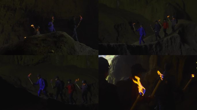 探险家团队举着火把黑暗中前行神秘洞中探险