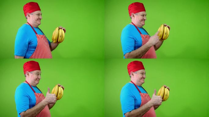 围裙上的高级厨师指着香蕉茎，赞同健康的生活方式。