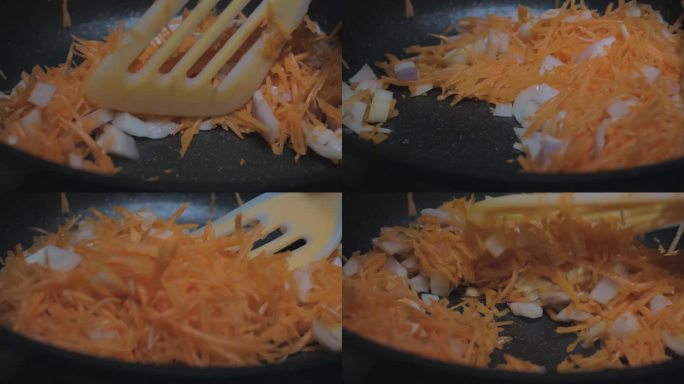 厨师特写:在煎锅里煎洋葱和胡萝卜