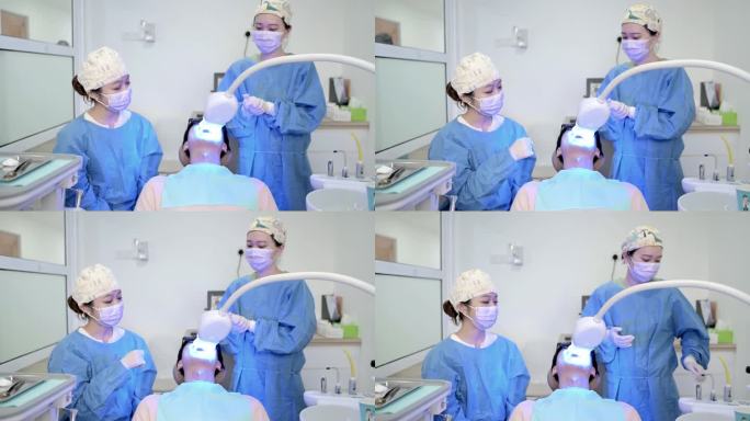 亚裔华裔女牙医正在为她的病人美白牙齿。