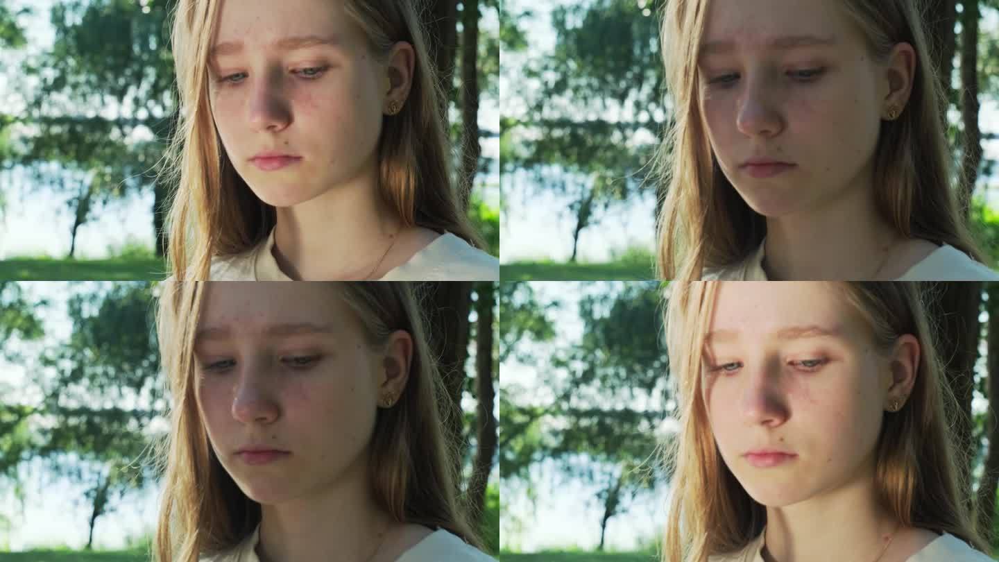 郁郁寡欢的少女在绿色城市公园哭泣