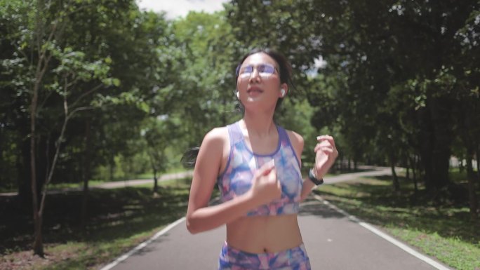 年轻女子在公园的马路上慢跑