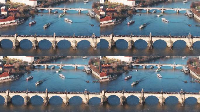 从空中俯瞰查理大桥，河上漂浮着多艘游船
