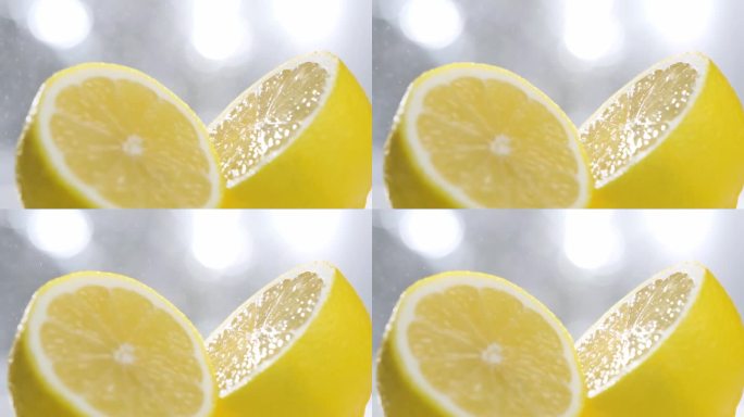 水喷雾颗粒落在新鲜的半切柠檬上，慢镜头拍摄