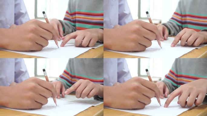 亚洲学生在课堂上使用橡皮擦书写学习考试。在高中的教育。学校学生的阅读笔记，评估在同学入学答卷上的写作