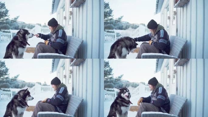 在挪威特朗德拉格郡的因德雷弗森，一位绅士和他的阿拉斯加雪橇犬坐在一起，享受着一杯热饮