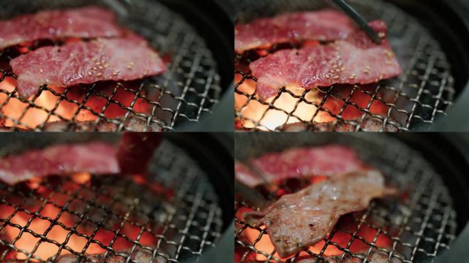 日本日式烤肉店，在明火烤架上烤和牛片。