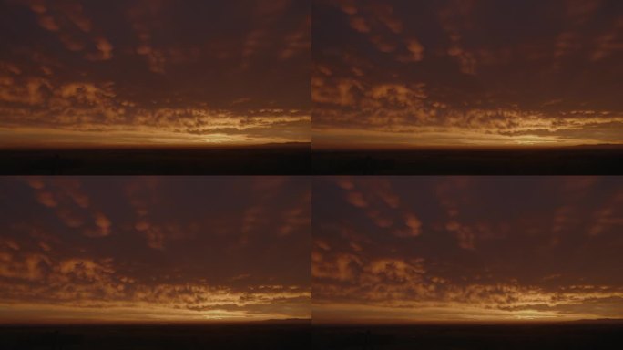 夕阳下，广袤的田野映衬着忧郁的天空