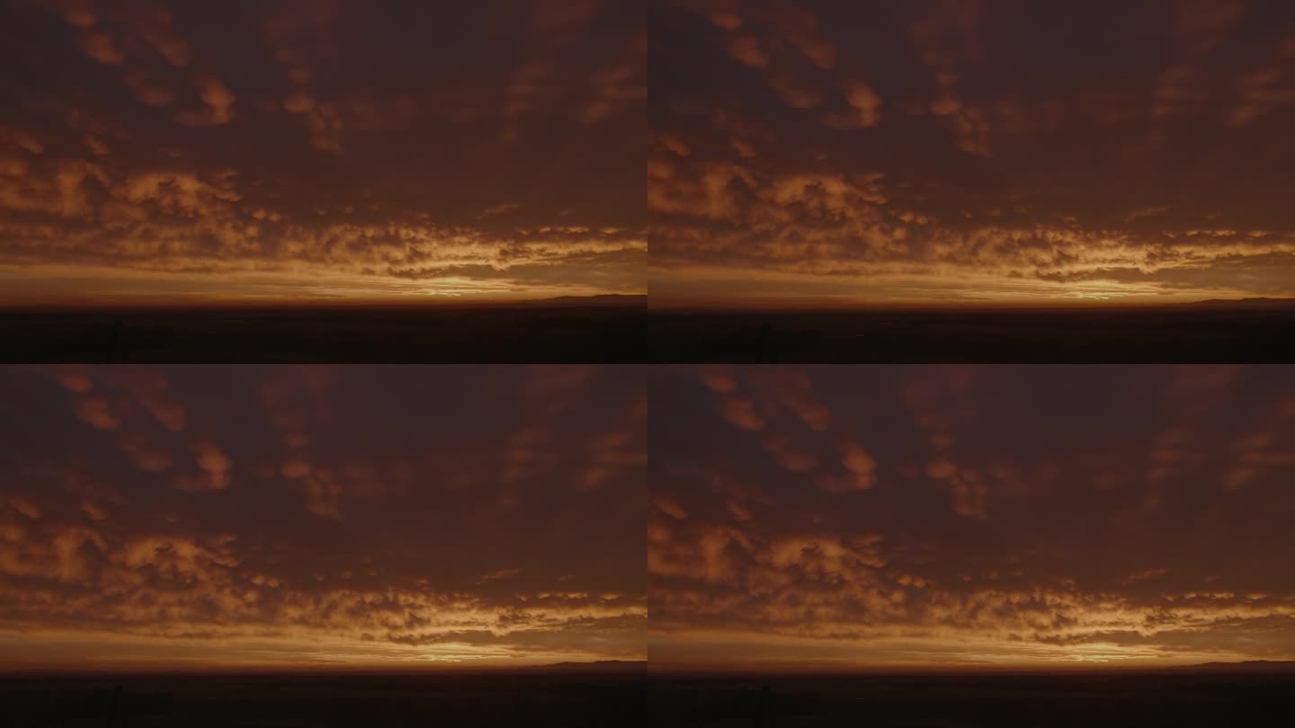 夕阳下，广袤的田野映衬着忧郁的天空