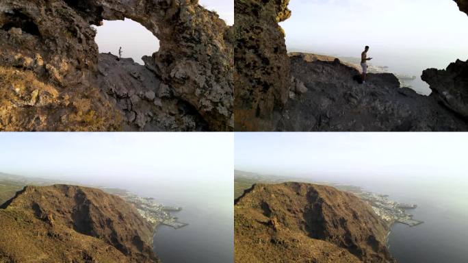 航拍视频经过Los Gigantes Hole，展示了特内里费岛的圣地亚哥港。太阳把金色的光芒洒在山