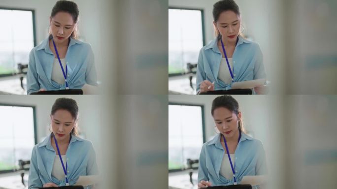 专注和专注的工作与亚洲女性专注于她的工作任务，在办公室专业，专注和富有成效的工作环境，使其成为一个理