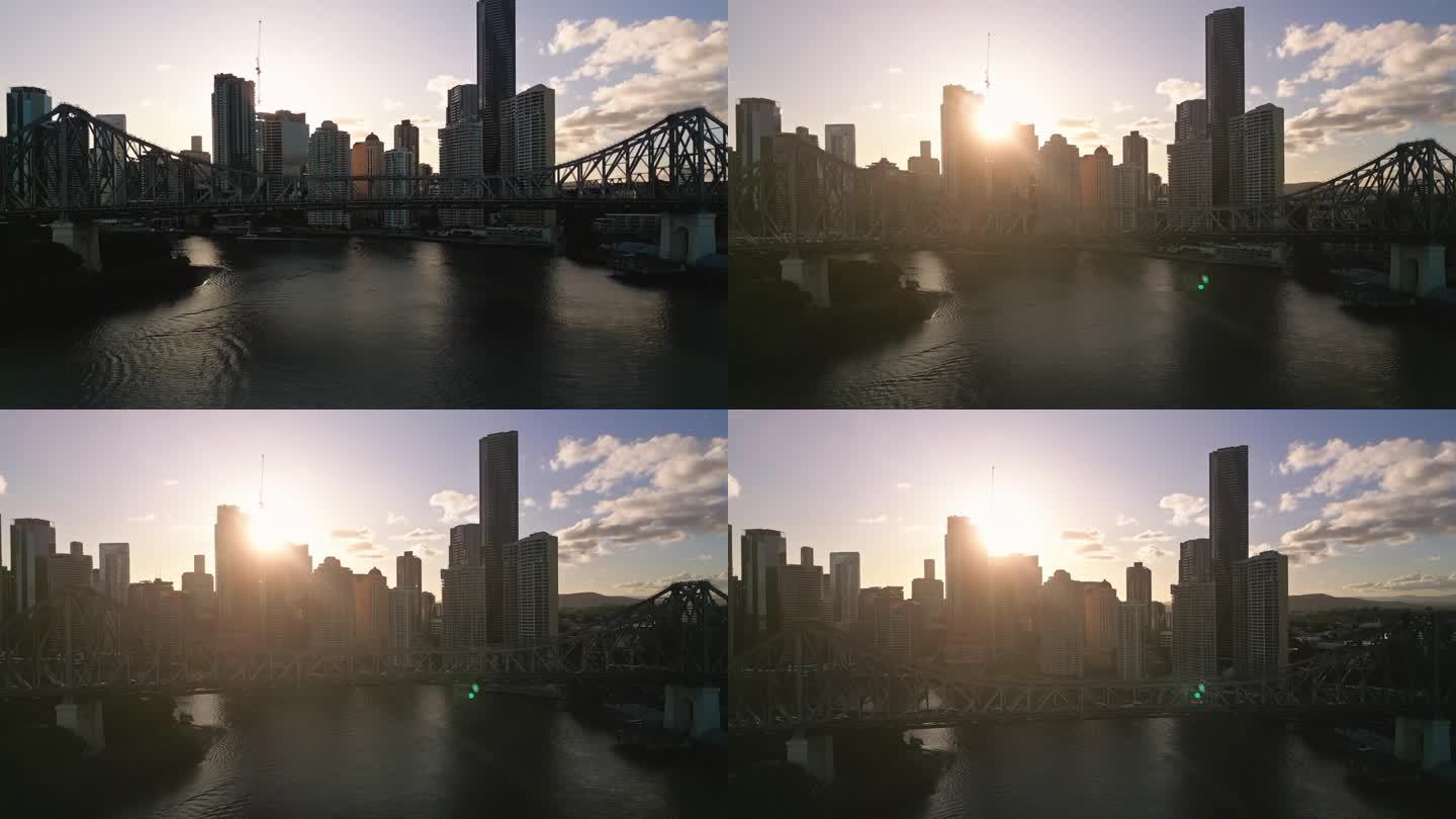 日落时分，澳大利亚昆士兰州布里斯班，布里斯班故事桥上拥挤的交通和现代办公大楼的4K鸟瞰图实时镜头
