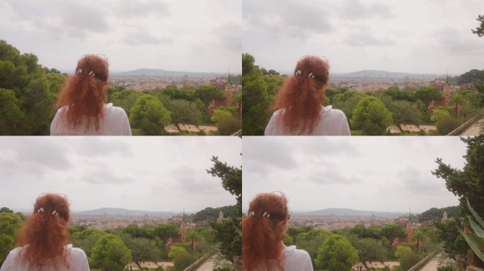 一名女子从安东尼·高迪的Guell公园俯瞰巴塞罗那