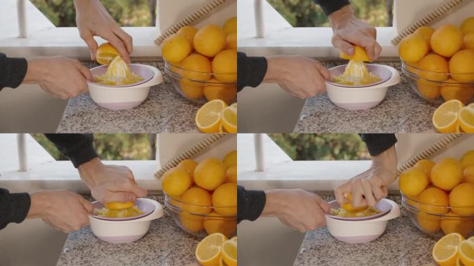 男子的双手从橙子中榨汁，背景是正在结果的树木。