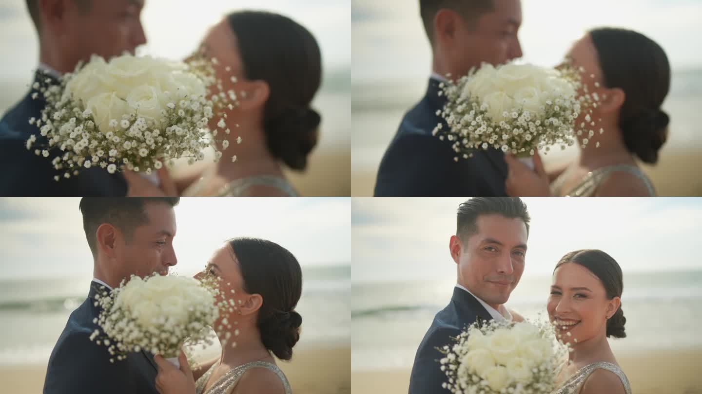 新娘和新郎在沙滩上拥抱的照片