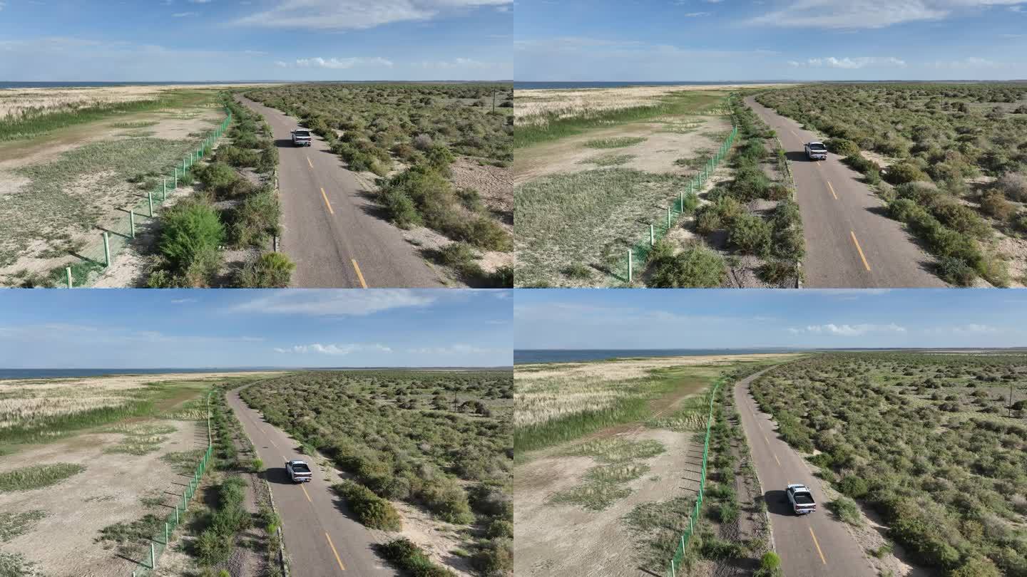 荒漠干旱地区中穿行的汽车国土复绿生态修复